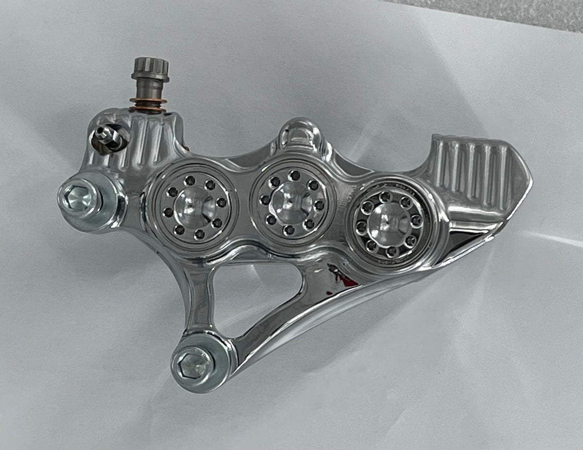 American Suspension B-62 six-piston caliper — raw aluminum finish